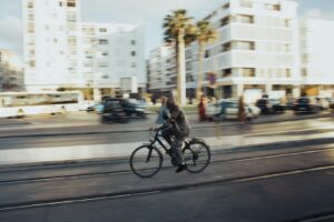 A person rides a bicycle on a city street.